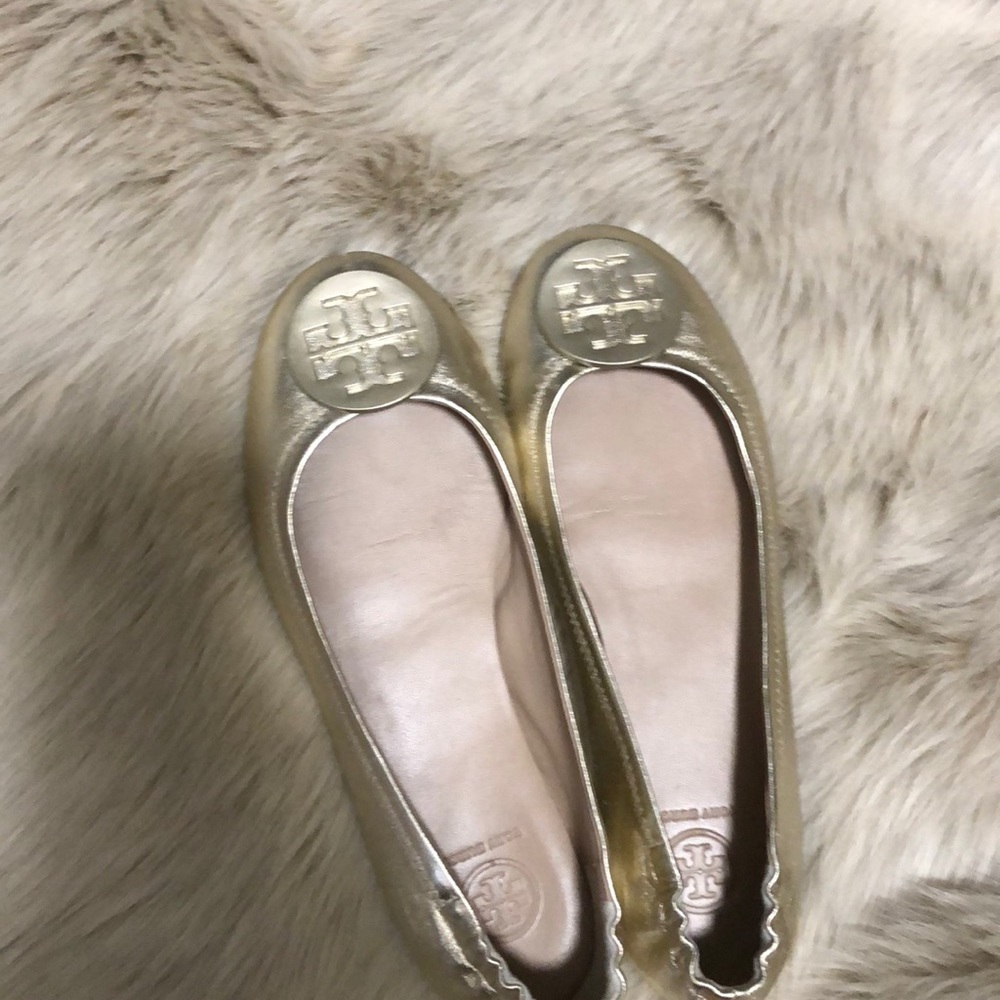 Tory Burch gold ballet flats.